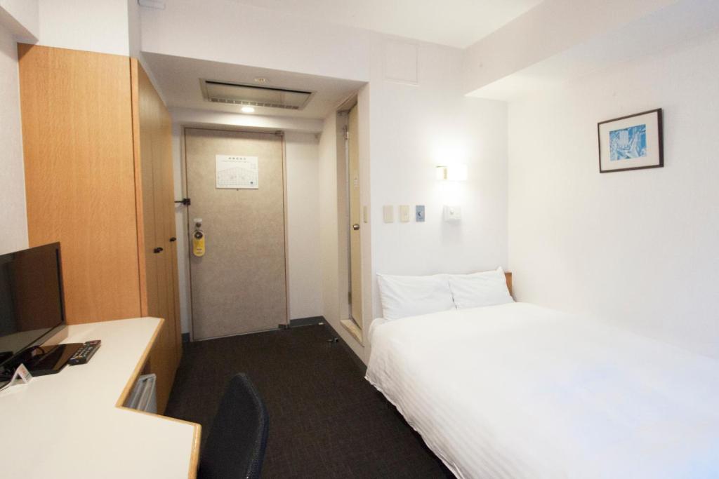 Postel nebo postele na pokoji v ubytování Smile Hotel Tokyo Tamanagayama