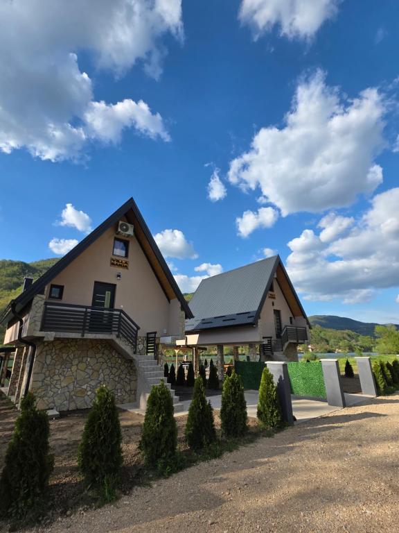 a large building with a porch and a roof at Villa Sanja I Villa Aleksa in Bratunac