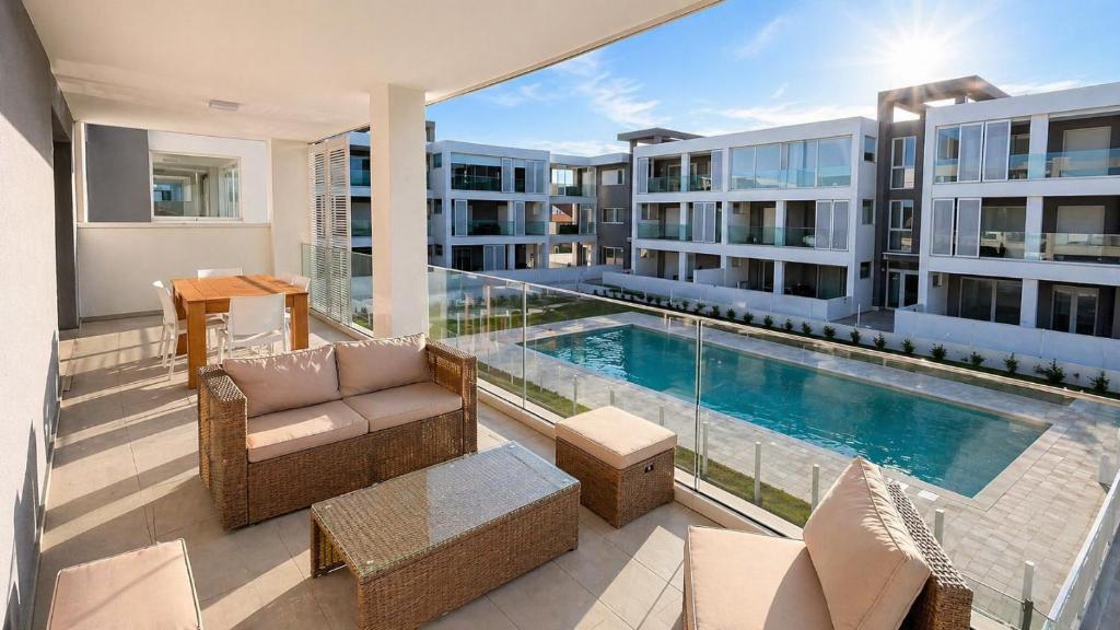 a balcony with a swimming pool and a building at Casa Amarèa in Fano