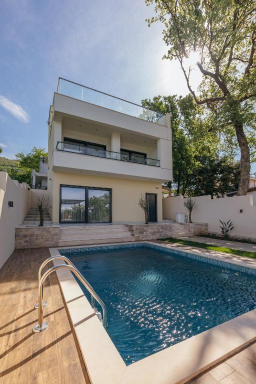 a house with a swimming pool in front of a house at Villa MIO in Bar