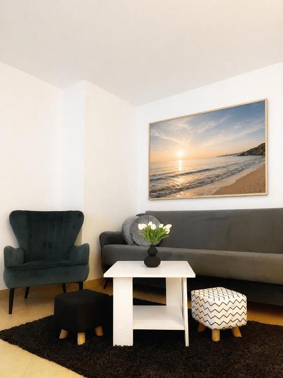 a living room with a couch and a table at Apartman Ćosić in Kruševica