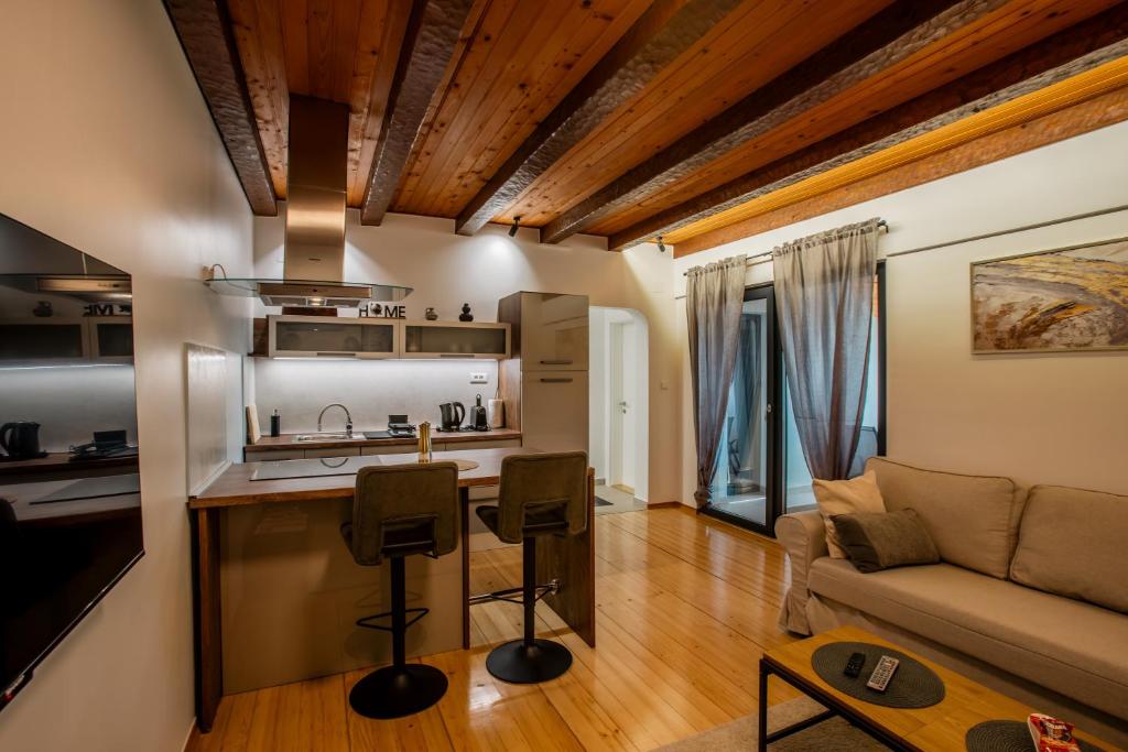 a kitchen and living room with a couch and a table at UrbanApartment5 in Čakovec