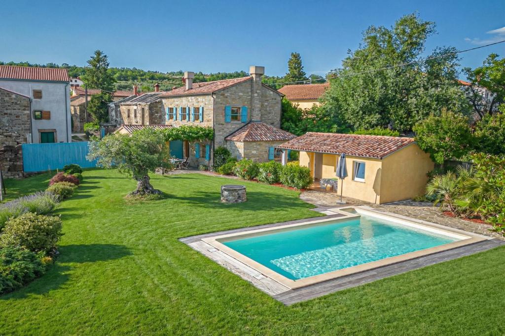 a yard with a swimming pool and a house at Rustic Villa Lavanda - Pool & Garden - Happy Rentals in Šmarje