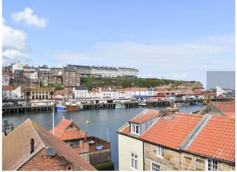 a city with a harbor with boats in the water at Annie Place in Whitby