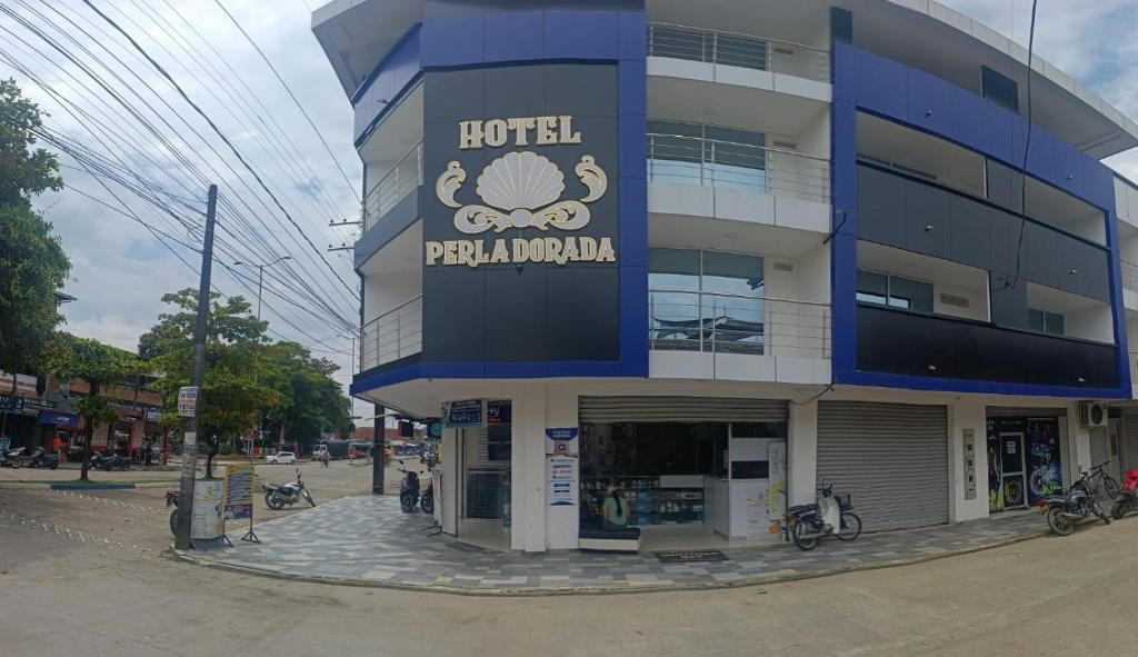 a hotel with a sign on the front of it at Hotel Perla Dorada in San Miguel