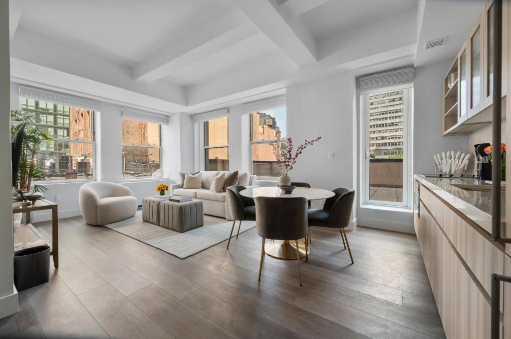 a living room with a table and chairs at 17John Residences in New York
