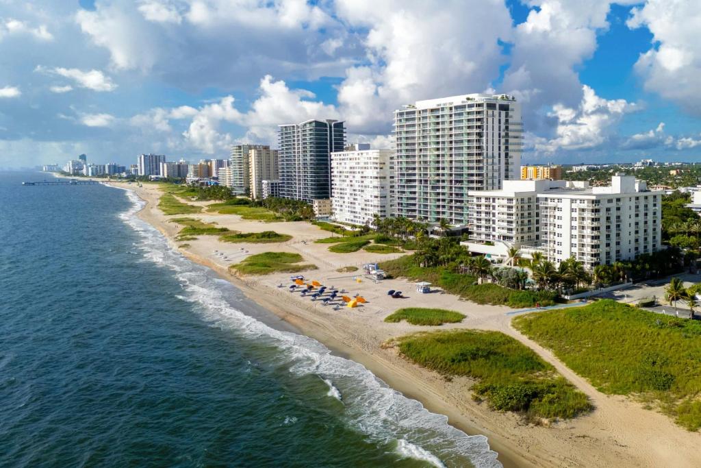 an aerial view of a beach in front of a city at Fort Lauderdale Marriott Pompano Beach Resort in Pompano Beach