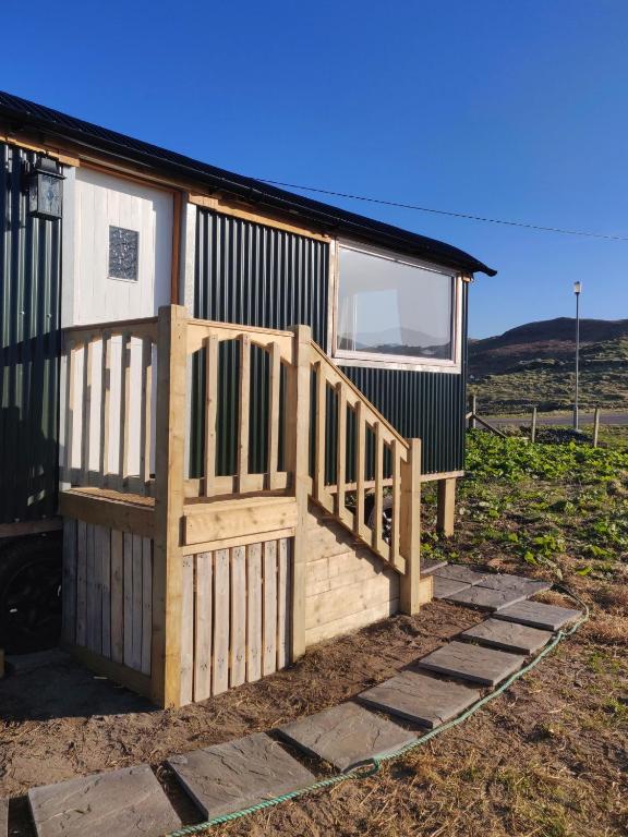 a house with a wooden porch and a deck at Bothan na Mara in Valtos