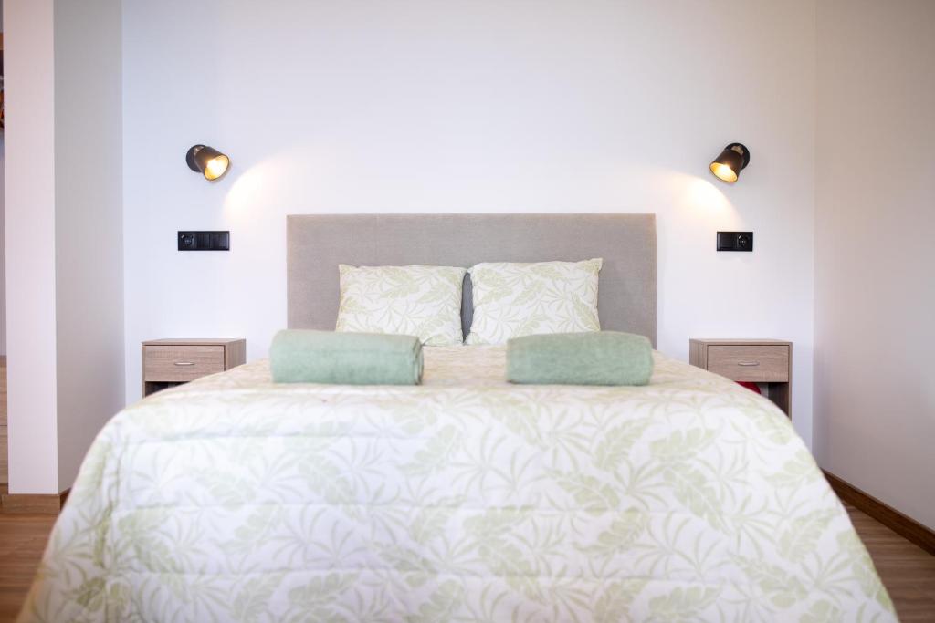a bedroom with a large bed with two pillows at Cantinho FF in Santana