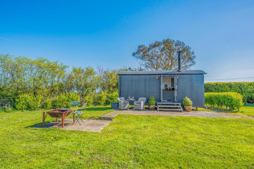 a shed with a table and chairs in a yard at 1 Bed in Narberth oc-83862 in Whitland