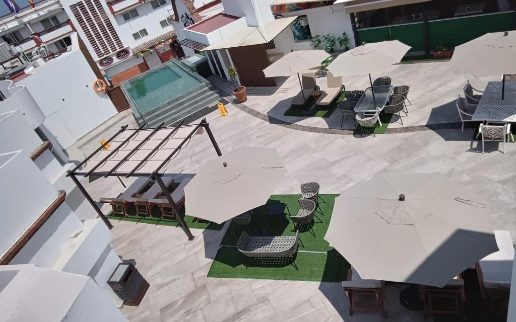 an overhead view of a patio with tables and umbrellas at Loft Hotel Malecón Vallarta in Puerto Vallarta