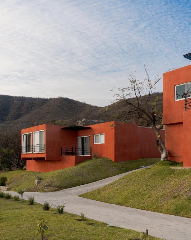 a rendering of a red building with a mountain in the background at Casa Maja Villas Chapala in Chapala