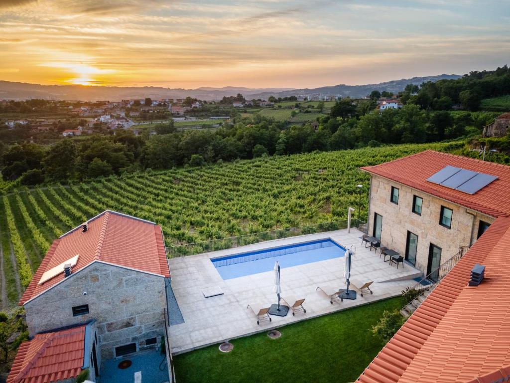 an aerial view of a house with a swimming pool at Outeyro Retreat Country House in Marco de Canaveses