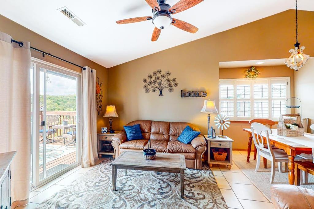 a living room with a couch and a table at Woodpecker's Tree in Branson