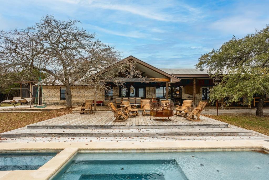 a house with a swimming pool in front of a house at Pool, Porch & Stunning Views: Spacious Texas Home! in Glen Rose