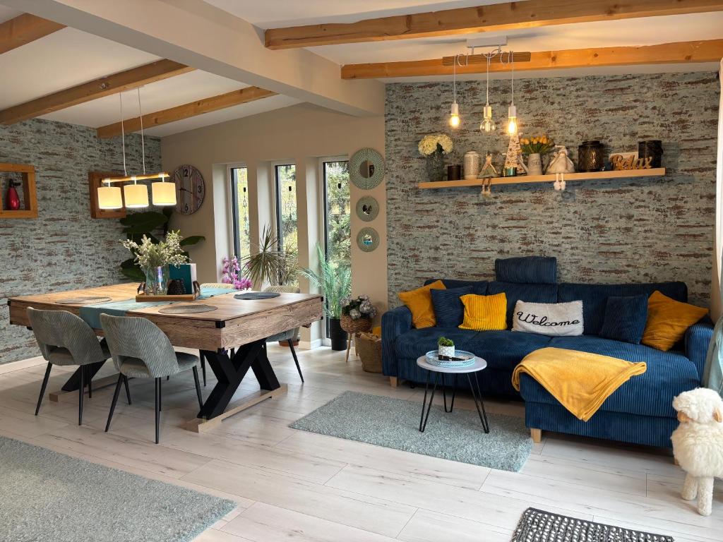 a living room with a blue couch and a table at Zebikuckó vendégház in Zebegény