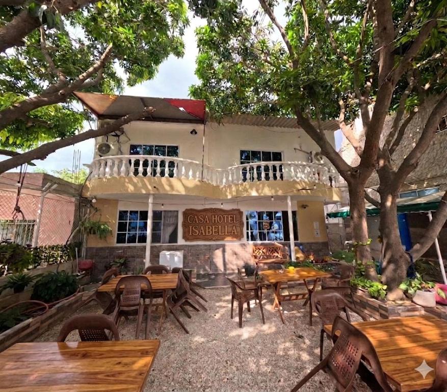 a restaurant with tables and chairs in front of a building at Casa Hotel Isabella in Santa Marta