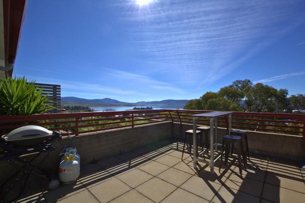 a balcony with a view of the water at Tanderra 17 28 Park Road in Jindabyne