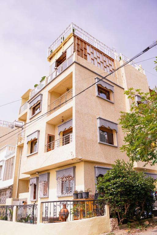 a tall building with balconies on the side of it at Salty Life Surf House in Imsouane