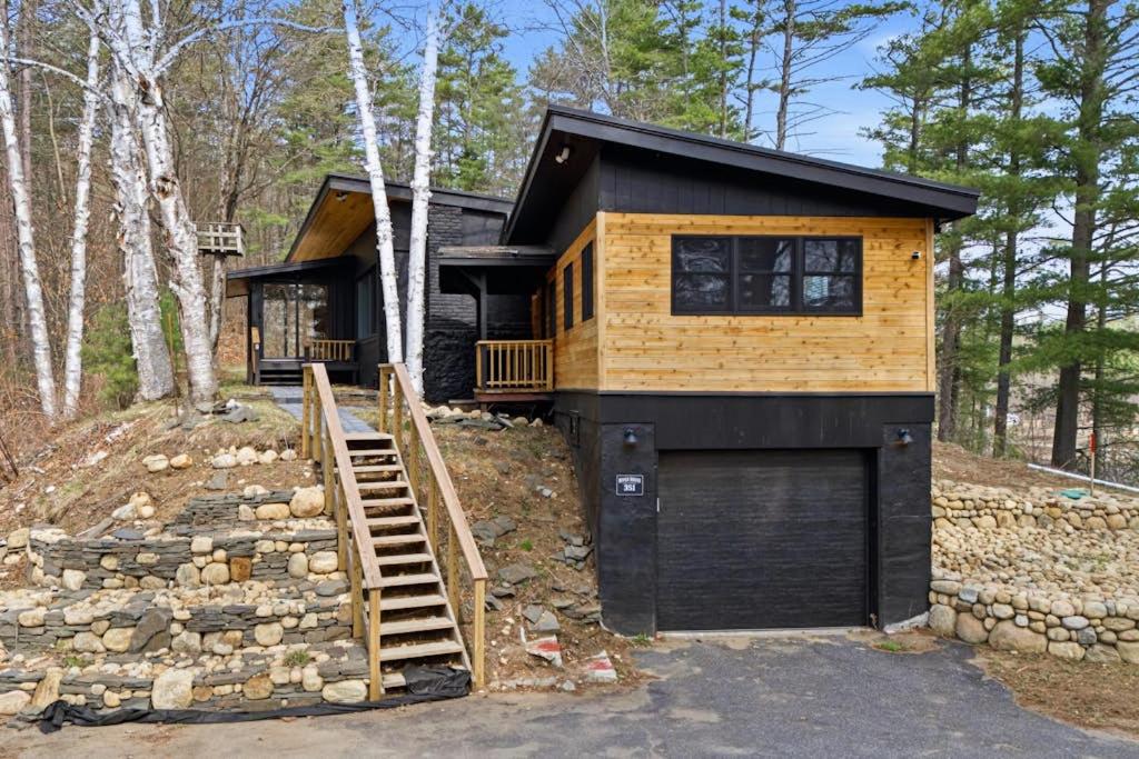 a tiny house with a garage in the woods at River House in North Creek