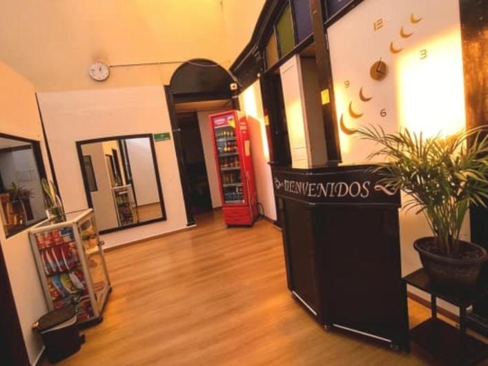 a room with a book store with a red phone booth at Hospedaje Luna Dorada in Manizales