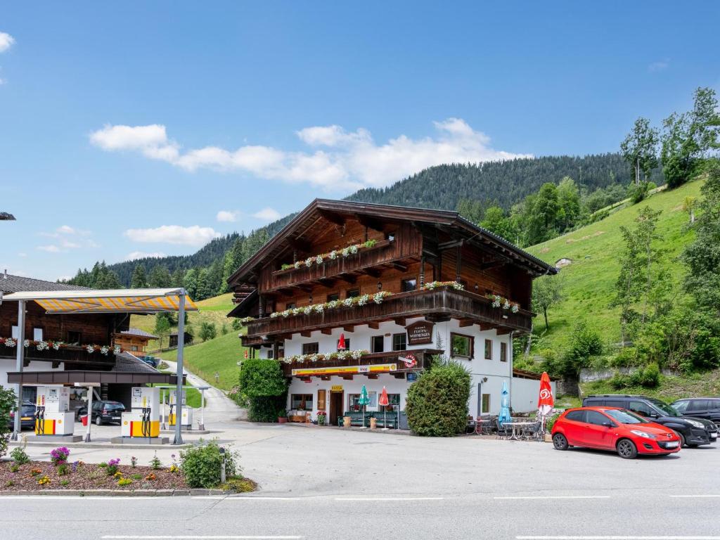 a building with a red car parked in a parking lot at Zellner Top 9 in Alpbach