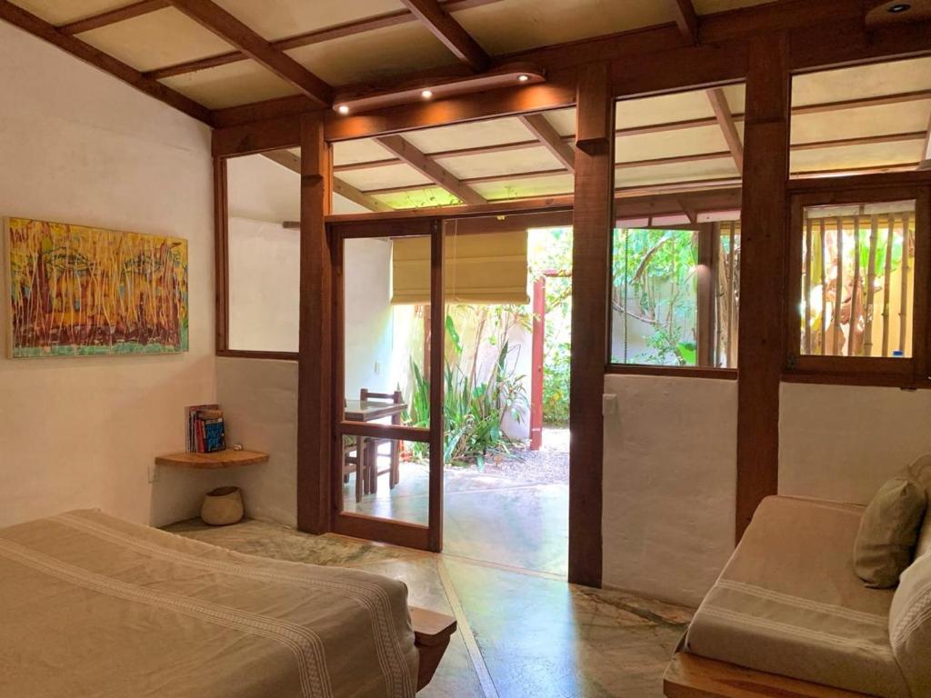 a bedroom with a bed and a sliding glass door at Galería Suites San Pancho in San Francisco