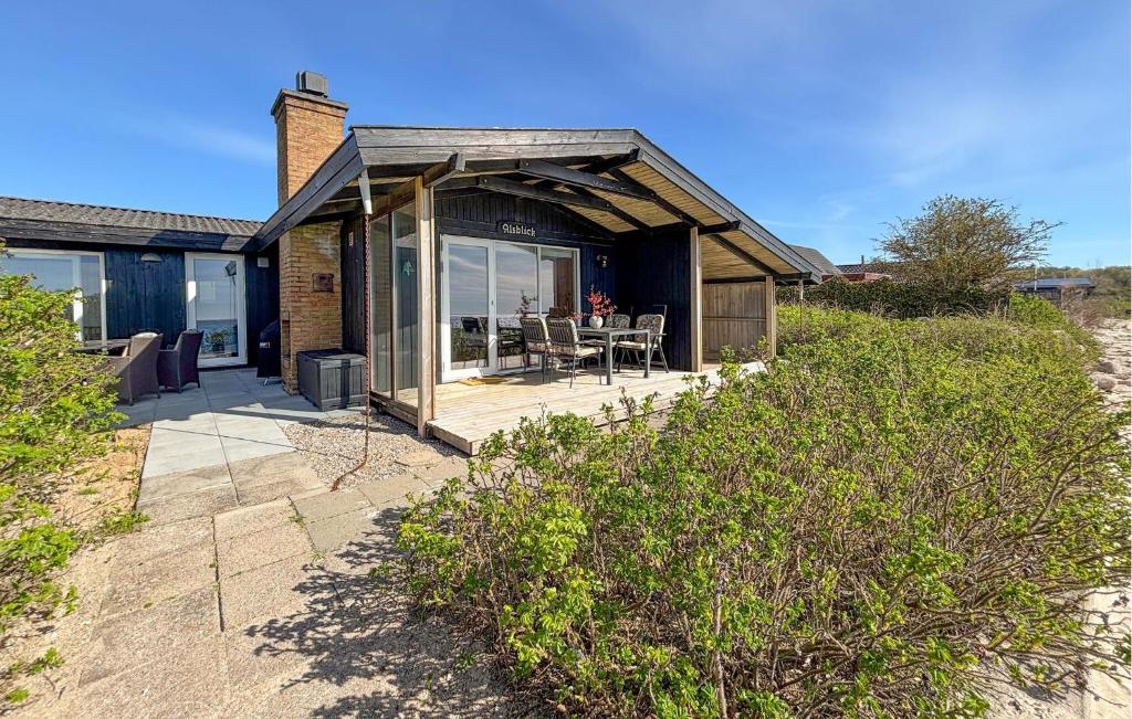 a house with a porch with a table and chairs at Beautiful Home In Haderslev With Wifi in Haderslev