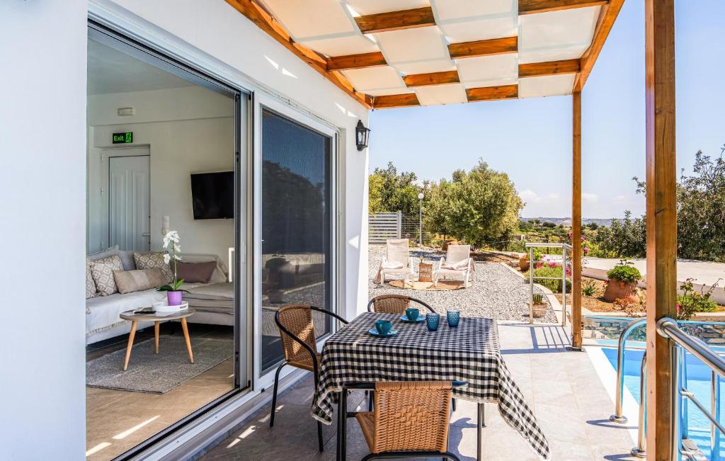 a patio with a table and chairs on a balcony at Daphne 2 in Agia Galini
