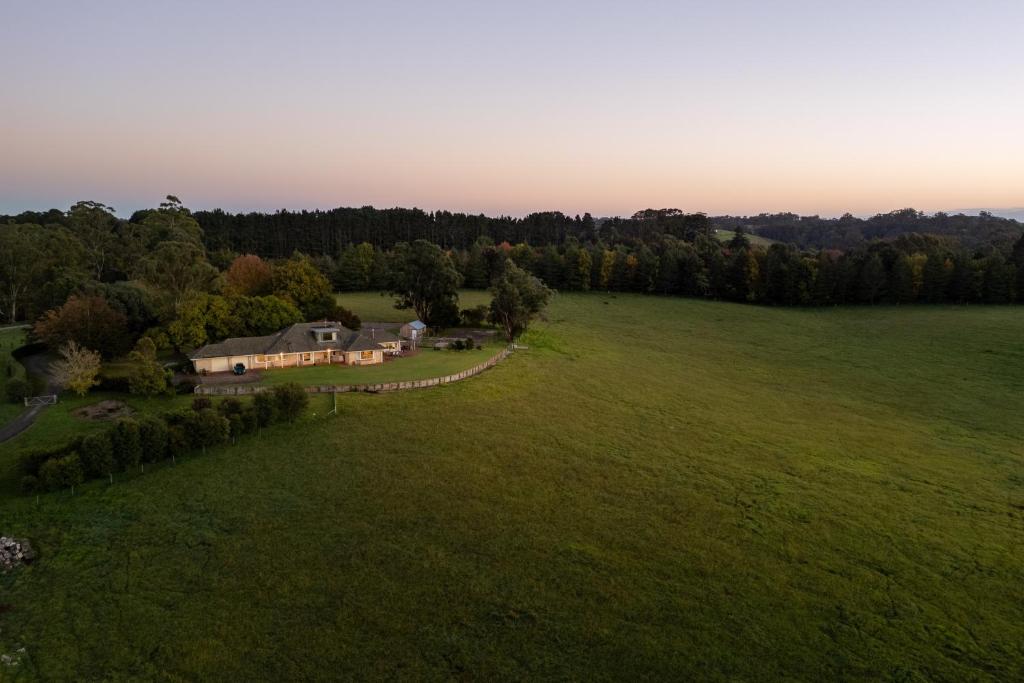 an aerial view of a house in a field at Wingana Homestead - Scenic Views, Bundanoon in Bundanoon