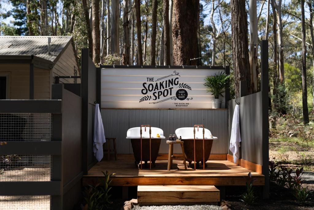 a couple of chairs sitting on a deck next to a trailer at The Duckling in Glenlyon