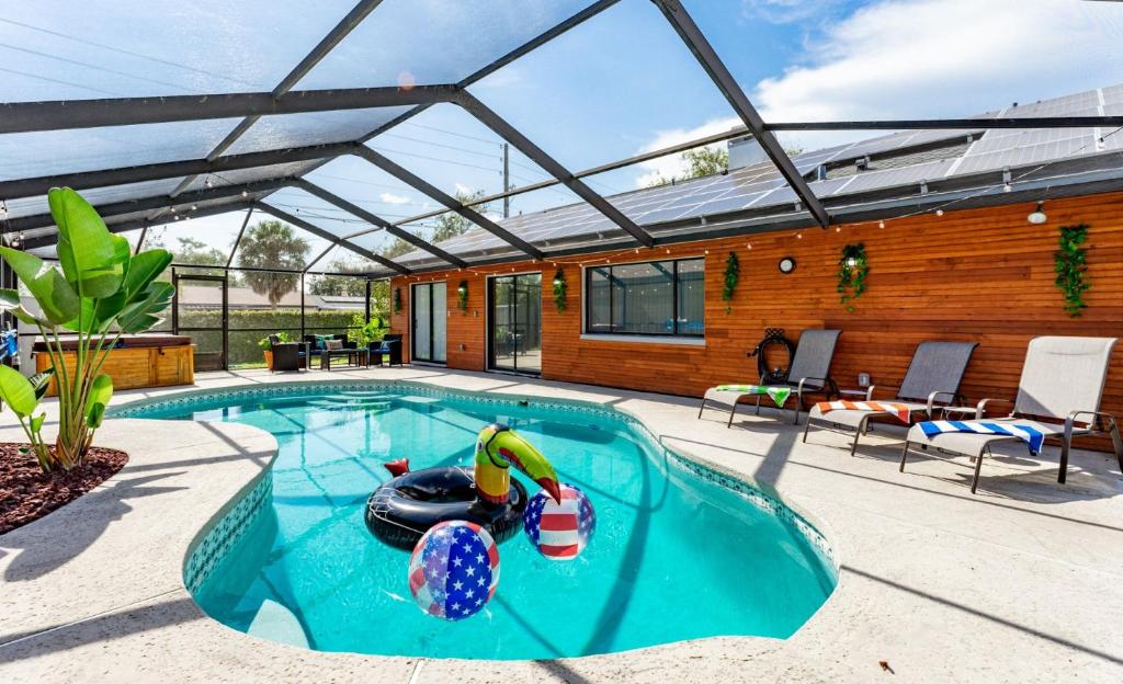 a swimming pool with a pool noodle in a backyard at The Pelican/Pool/HotTub/GameRoom in Brandon