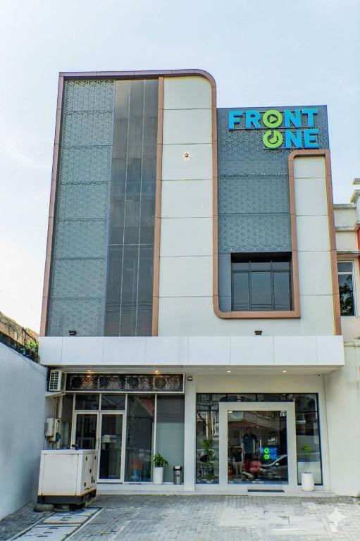 a front of a building with a sign on it at Front One Budget Hotel Tirtonadi Solo in Solo