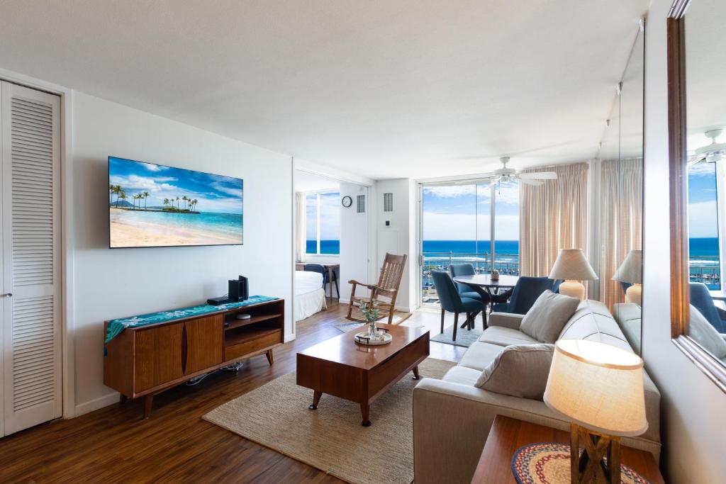 a living room with a couch and a table at Ilikai Marina 1394 in Honolulu