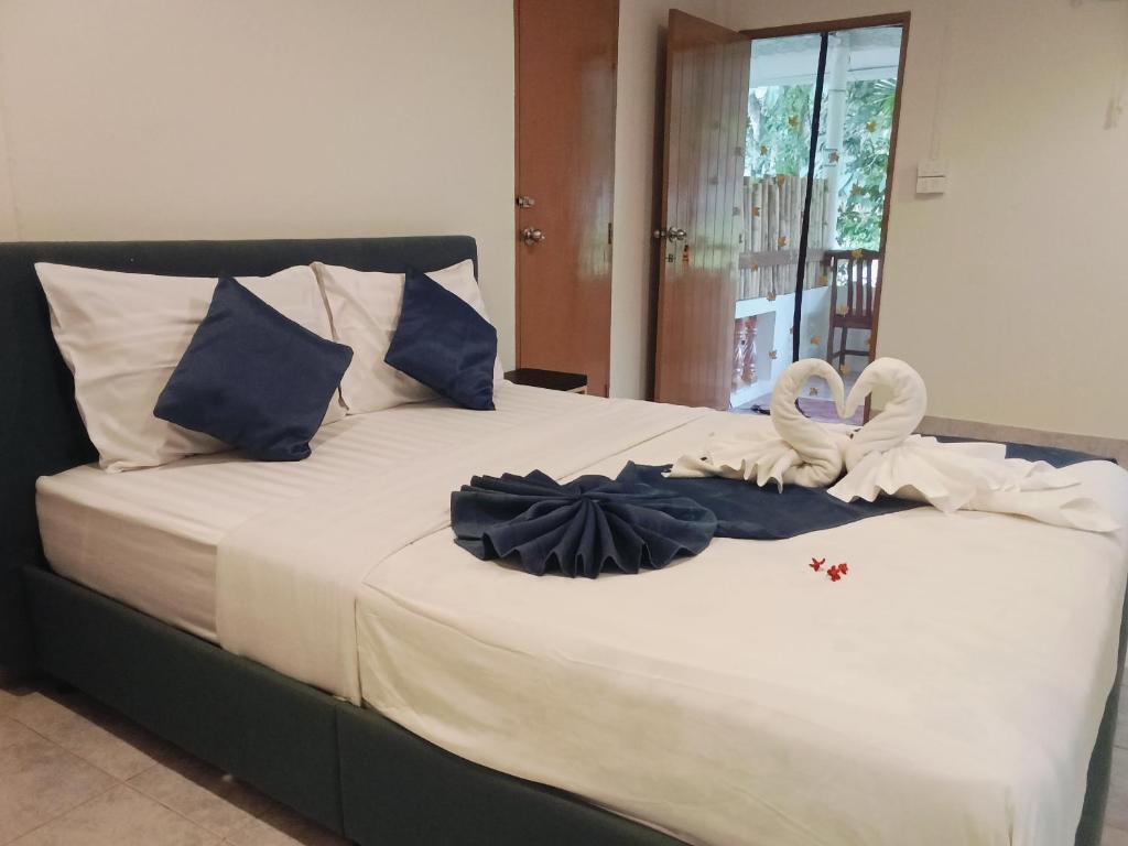 a bed with towels and swans sitting on it at Little house in Koh Samui