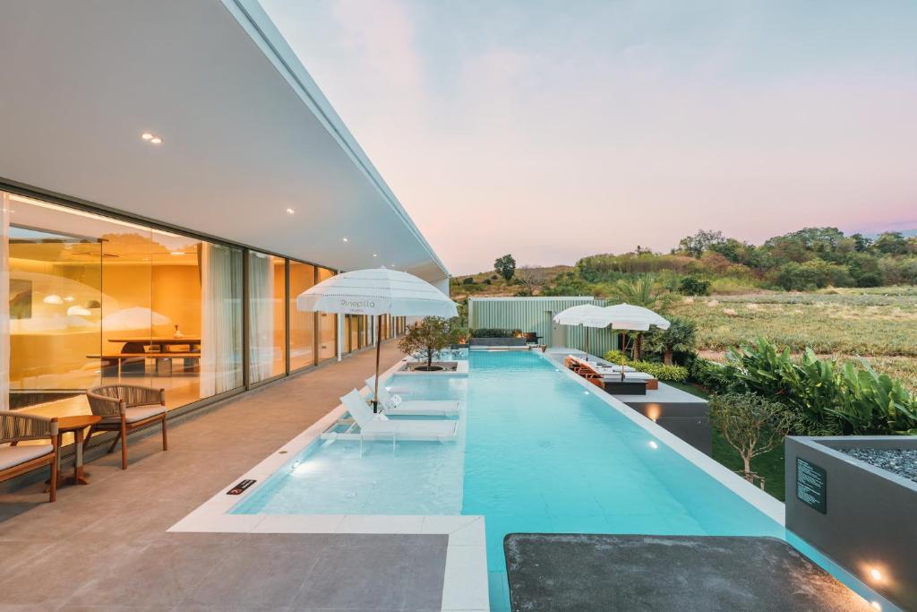 a swimming pool in the middle of a house at Pinepilla Poolvilla Huahin in Hua Hin