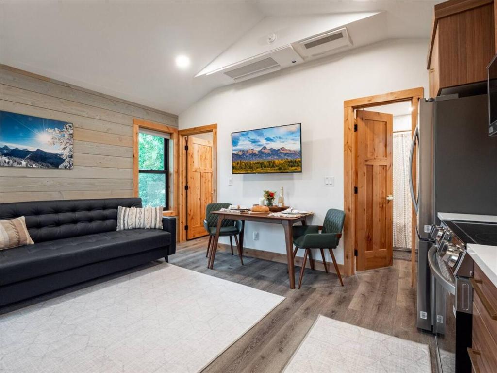 a living room with a couch and a table at Alpenhaus | Ski Jackson & Targhee in Victor