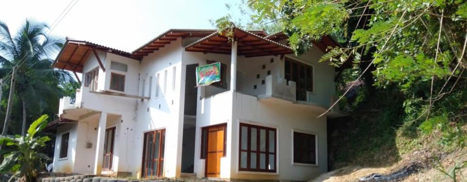a white building with a sign in front of it at RanaHansa Villa in Kegalle