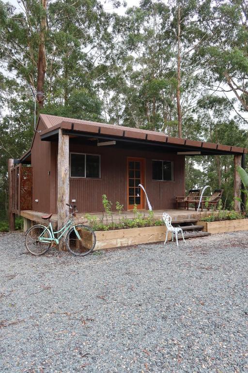 a small house with a bike parked in front of it at Amoré Cabin in Ocean View