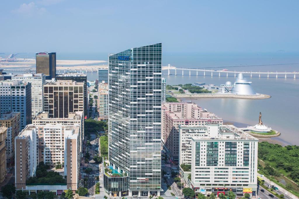 an aerial view of a city with a bridge at Ascott Macau in Macau