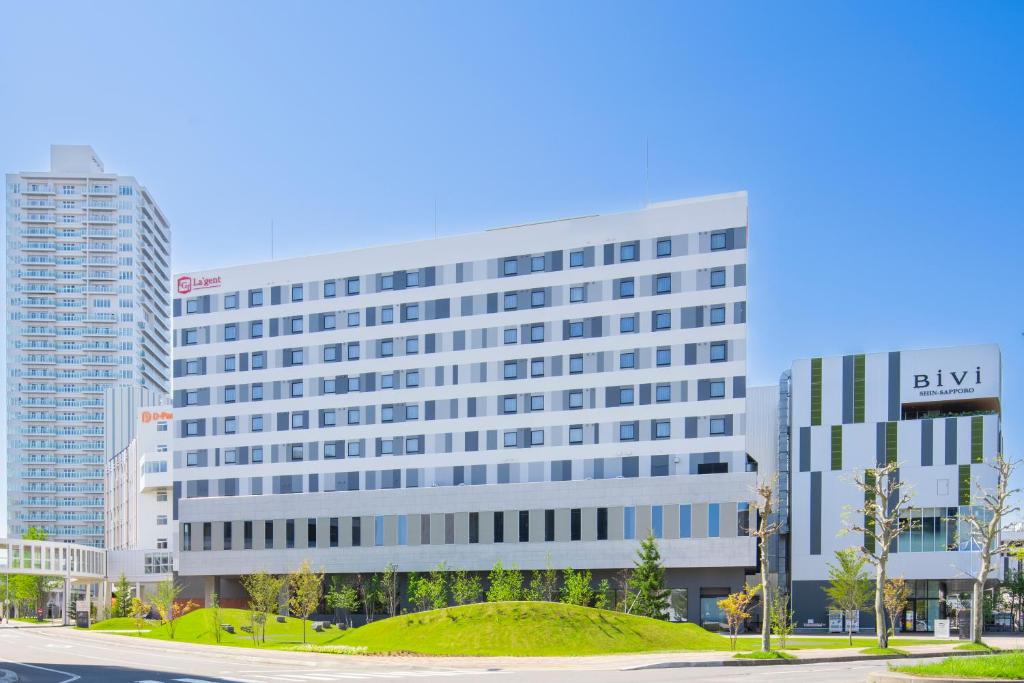 a large white building with a sign on it at La'gent Stay Shin Sapporo in Sapporo