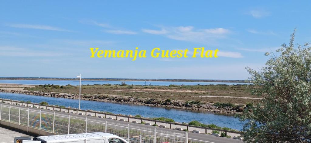 a bus driving down a road next to a river at Yemanja Guest Flat- vue Mer &Salin, piscine, climatisation in Gruissan