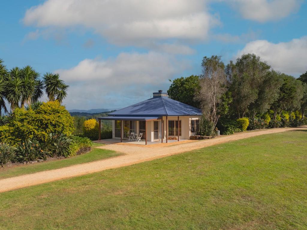 a house with a blue roof in a field at Summergrove Estate in Carool