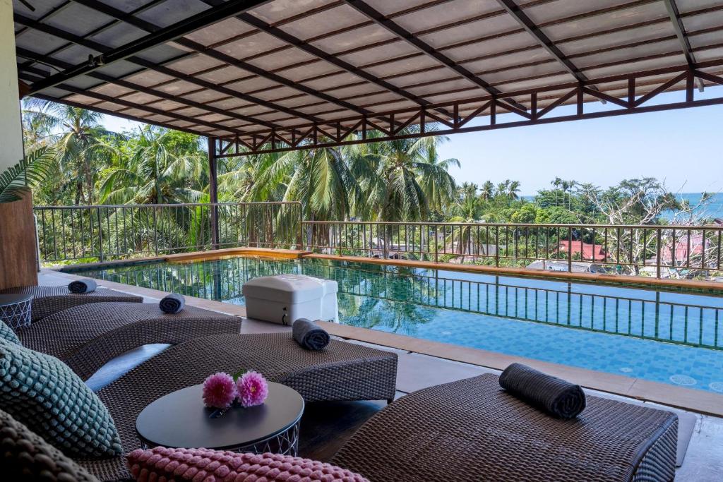 a view of a swimming pool from a resort patio at 6 Bedrooms Seaview With Pool - Belle Sunset Villa in Ko Lanta
