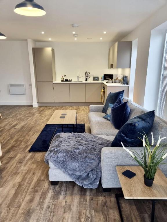 a living room with a couch and a table at Comfortable modern apartment near Bicester in Bicester