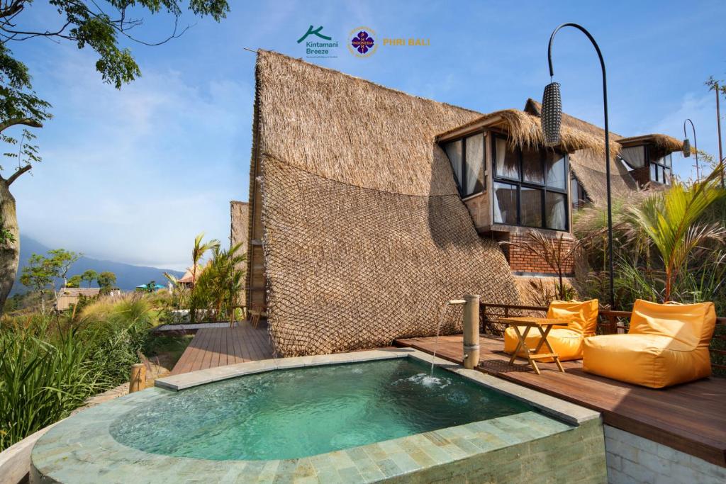 a swimming pool on a deck with a house at Kintamani Breeze in Kubupenlokan