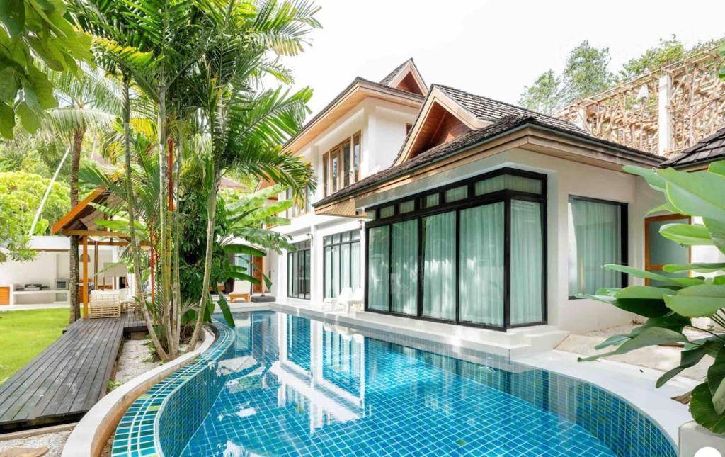 a swimming pool in front of a villa at Chalong Thai-Style Pool Villa in Phuket