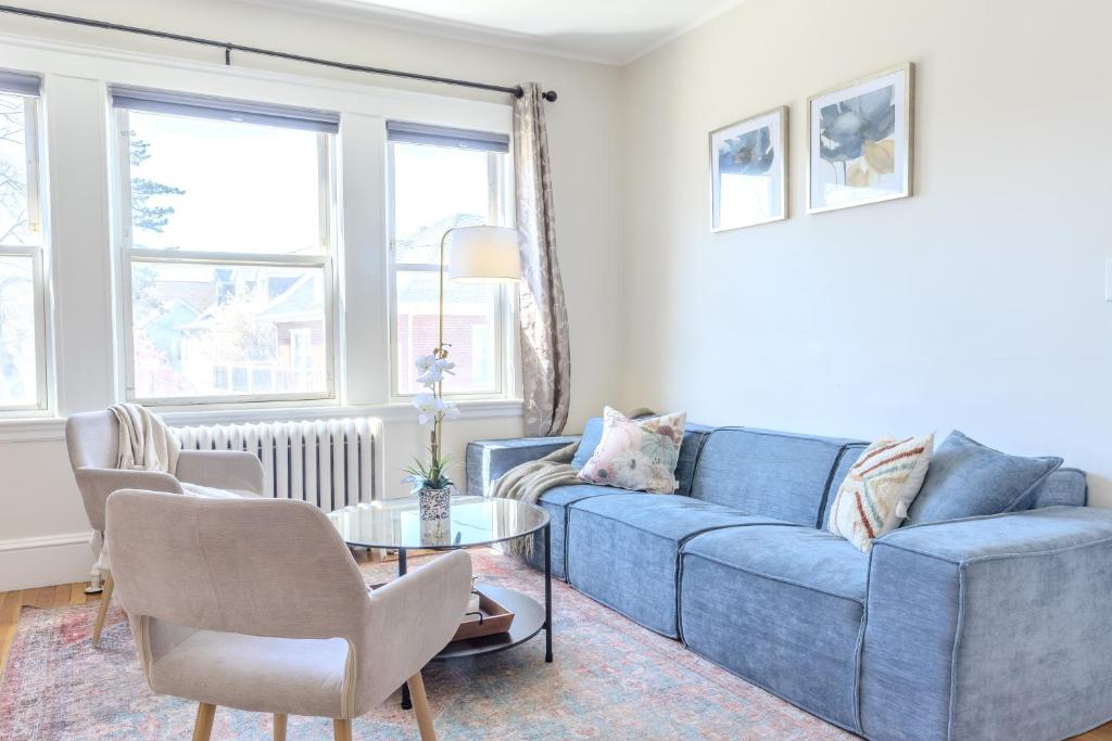 a living room with a blue couch and a table at Brighton 2 bedroom in Boston