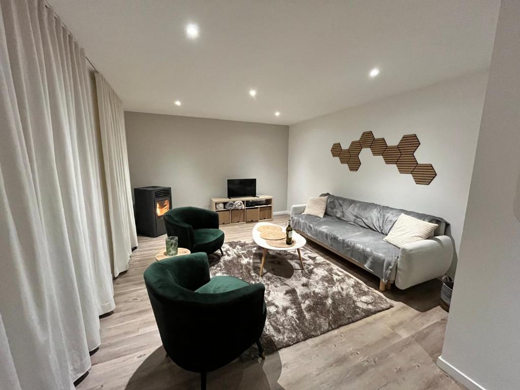 a living room with a couch and two chairs at Le Cosy Duplex in Amay