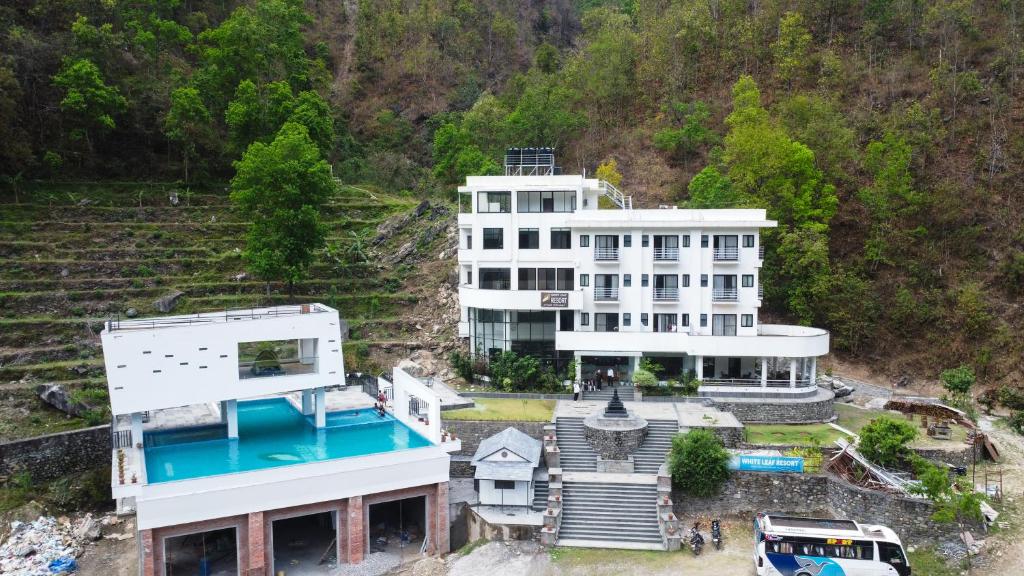an aerial view of a large white building at White Leaf Resort - Green River View Resort in Dolālghāt